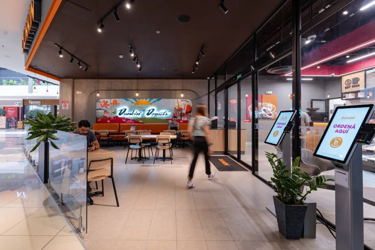 Dunkin Donuts - Self-service area with digital ordering kiosks and glass partitions - Contract Workplaces.webp